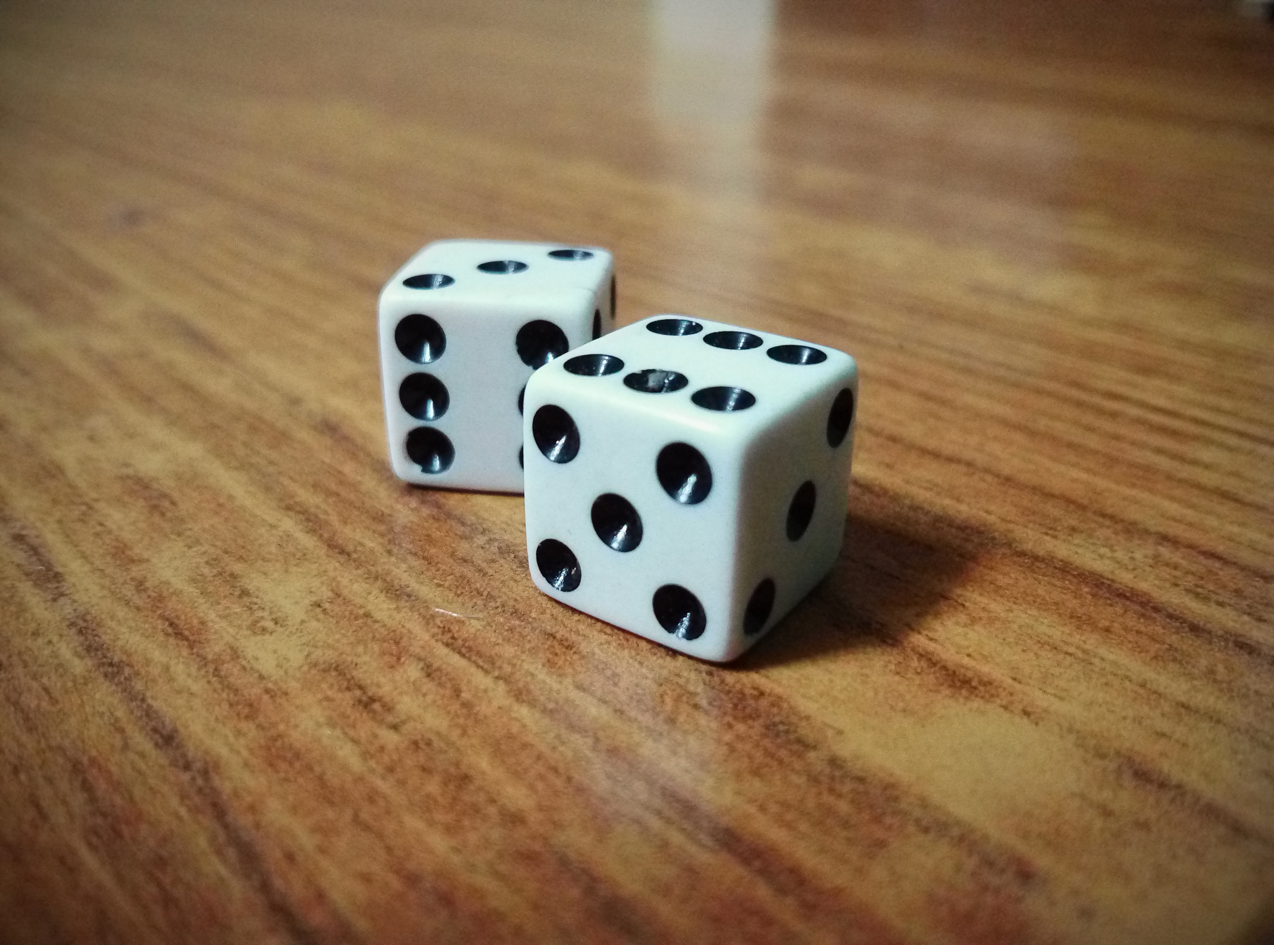 A pair of dice on wood table